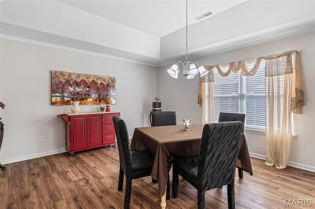 1654 Napoleon Dr, Bonne Terre, MO 63628 - dining space featuring dark wood-type flooring, a chandelier, baseboards, a tray ceiling, and crown molding