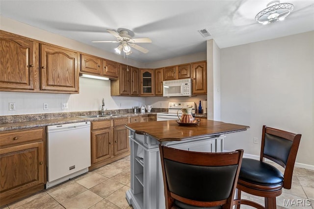 1654 Napoleon Dr, Bonne Terre, MO 63628 - kitchen featuring white appliances, a sink, light tile patterned floors, and brown cabinets