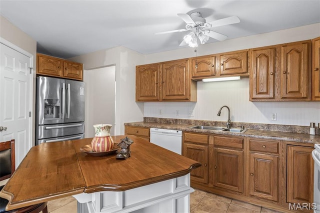 1654 Napoleon Dr, Bonne Terre, MO 63628 - kitchen with stainless steel refrigerator with ice dispenser, white dishwasher, a sink, light tile patterned floors, and brown cabinetry