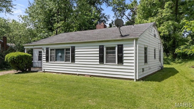 309 N Schlueter Ave, Saint Louis, MO 63135 - view of side of property with a chimney and a yard