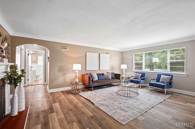 309 N Schlueter Ave, Saint Louis, MO 63135 - living area with arched walkways and wood finished floors