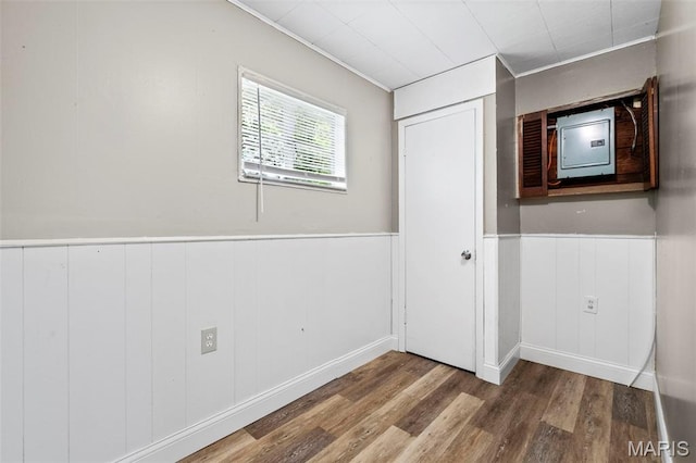 309 N Schlueter Ave, Saint Louis, MO 63135 - unfurnished bedroom featuring wood finished floors, a wainscoted wall, and crown molding