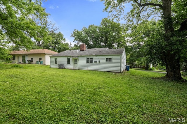 309 N Schlueter Ave, Saint Louis, MO 63135 - back of house with a lawn and a chimney