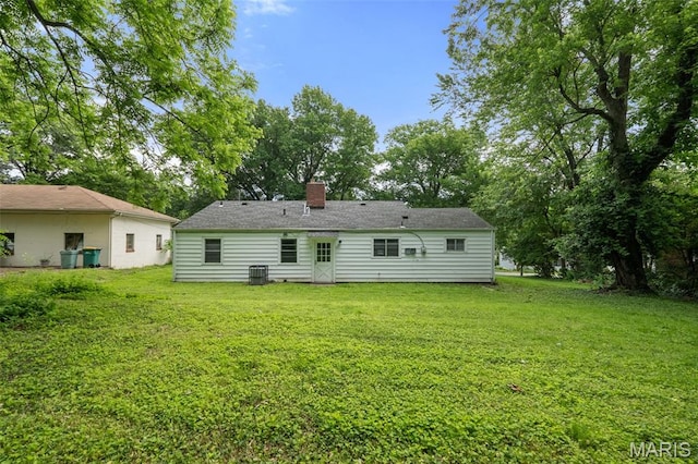 309 N Schlueter Ave, Saint Louis, MO 63135 - rear view of house with a yard, a chimney, and view of wooded area