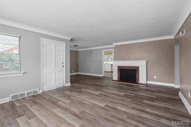 309 N Schlueter Ave, Saint Louis, MO 63135 - unfurnished living room featuring wood finished floors and a fireplace