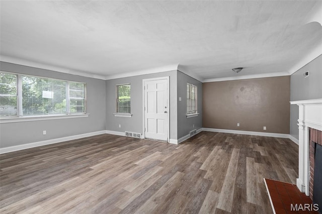 309 N Schlueter Ave, Saint Louis, MO 63135 - unfurnished living room featuring a fireplace and wood finished floors
