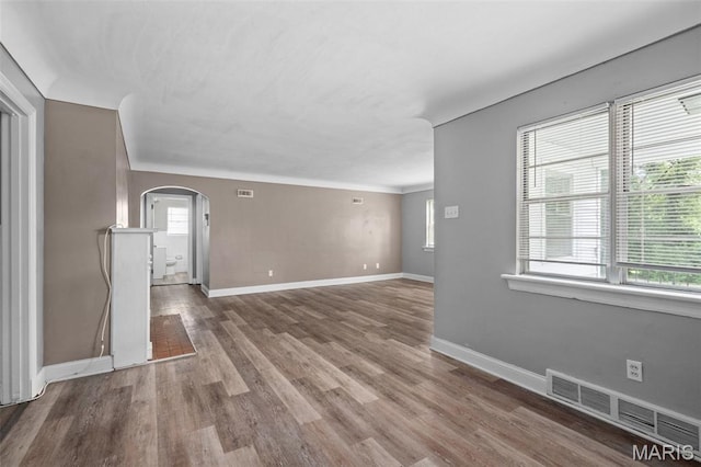 309 N Schlueter Ave, Saint Louis, MO 63135 - spare room featuring arched walkways and wood finished floors