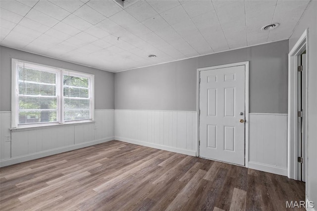 309 N Schlueter Ave, Saint Louis, MO 63135 - unfurnished room featuring a wainscoted wall and wood finished floors
