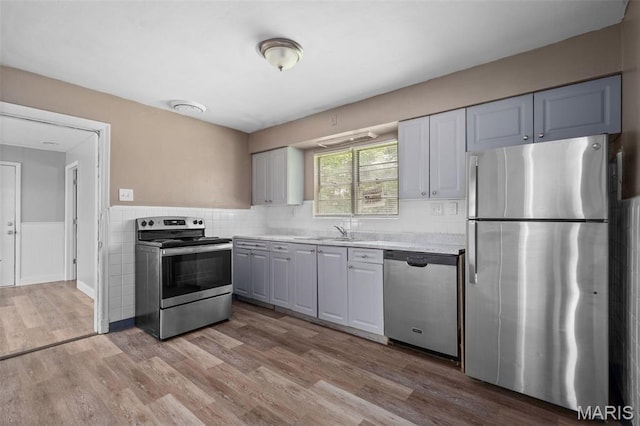 309 N Schlueter Ave, Saint Louis, MO 63135 - kitchen with stainless steel appliances, light countertops, and wood finished floors