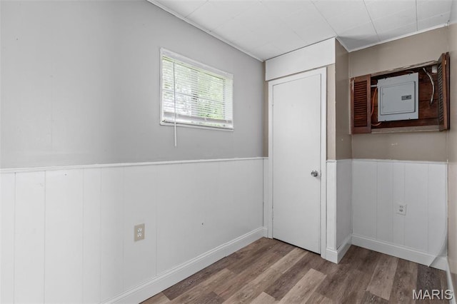 309 N Schlueter Ave, Saint Louis, MO 63135 - unfurnished bedroom featuring wood finished floors, electric panel, and wainscoting