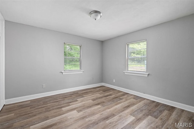 309 N Schlueter Ave, Saint Louis, MO 63135 - spare room with plenty of natural light and wood finished floors