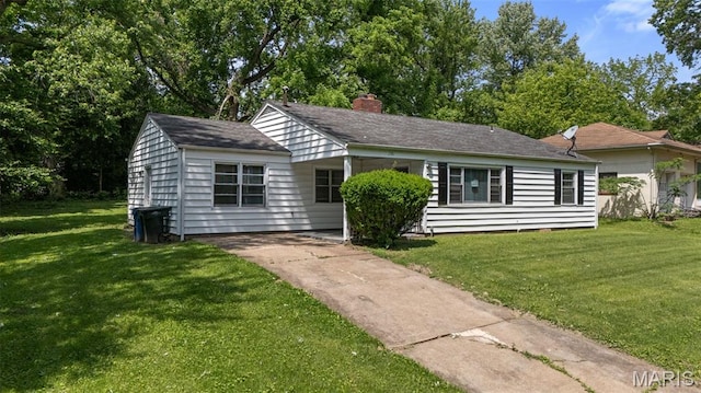 309 N Schlueter Ave, Saint Louis, MO 63135 - view of front of property featuring a front yard, concrete driveway, and a chimney