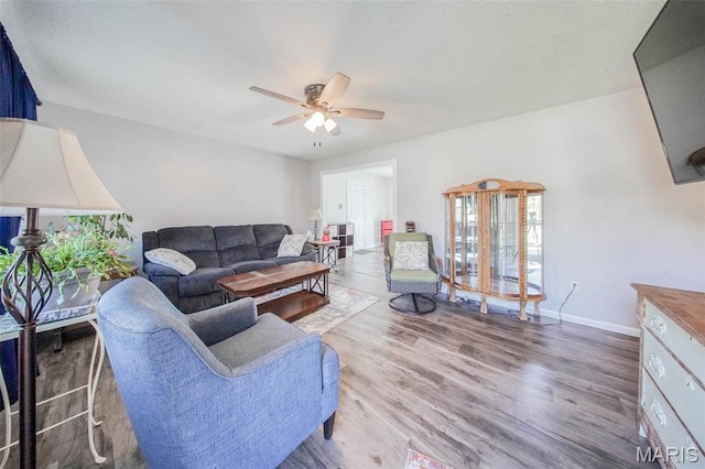 14056 State Route O, Rolla, MO 65401 - living area featuring a ceiling fan, wood finished floors, and baseboards