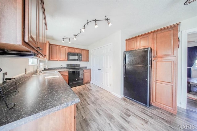 14056 State Route O, Rolla, MO 65401 - kitchen with black appliances, a sink, light wood finished floors, dark countertops, and baseboards
