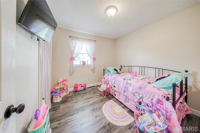 14056 State Route O, Rolla, MO 65401 - bedroom featuring wood finished floors, baseboards, and a textured ceiling