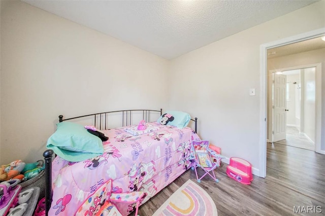 14056 State Route O, Rolla, MO 65401 - bedroom featuring wood finished floors, baseboards, and a textured ceiling