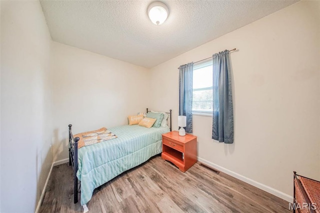 14056 State Route O, Rolla, MO 65401 - bedroom featuring a textured ceiling, light wood-type flooring, and baseboards