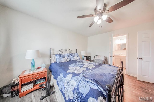 14056 State Route O, Rolla, MO 65401 - bedroom featuring wood finished floors, a ceiling fan, and ensuite bathroom