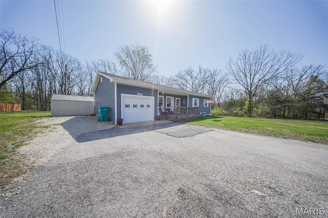14056 State Route O, Rolla, MO 65401 - ranch-style house with an attached garage, driveway, covered porch, and a front lawn
