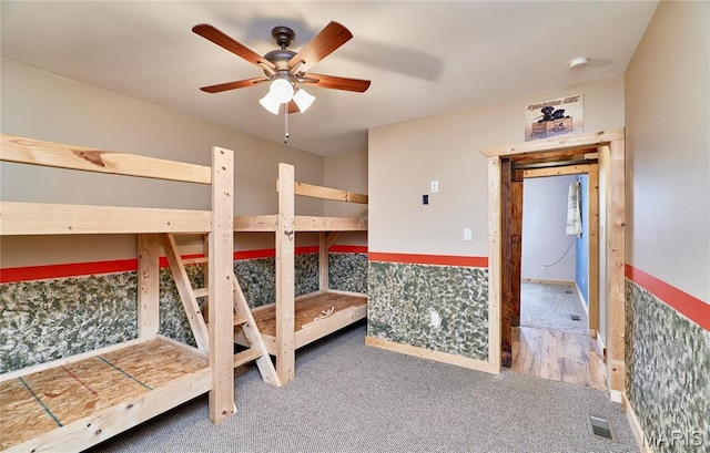 unfurnished bedroom featuring carpet floors and a ceiling fan