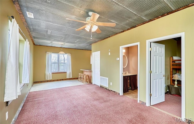 unfurnished bedroom featuring carpet floors, ornamental molding, and baseboards