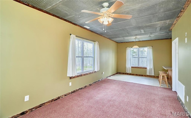 carpeted spare room featuring ceiling fan