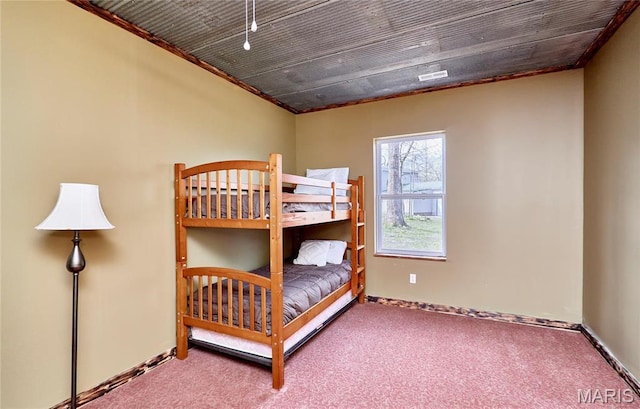 carpeted bedroom featuring baseboards