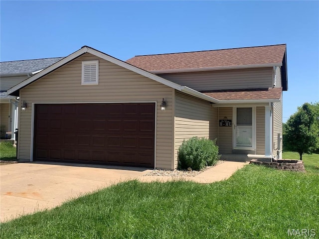 view of front of house with an attached garage, concrete driveway, roof with shingles, and a front yard