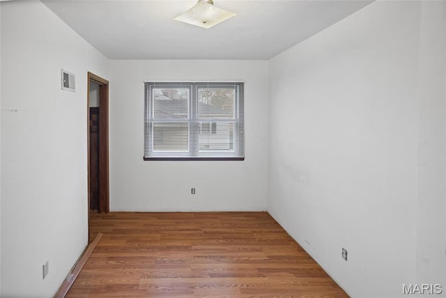 unfurnished room with wood finished floors