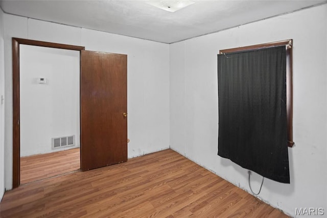 unfurnished room with wood finished floors