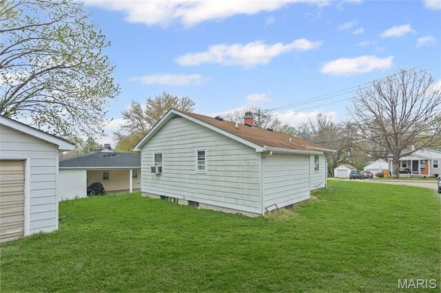 rear view of property featuring a lawn and cooling unit