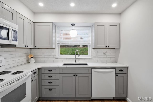 2014 Greenglen Dr Unit 101, Saint Louis, MO 63122 - kitchen featuring white appliances, a sink, gray cabinets, tasteful backsplash, and recessed lighting