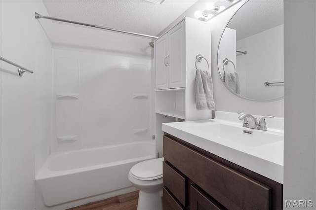 2014 Greenglen Dr Unit 101, Saint Louis, MO 63122 - bathroom with a textured ceiling, wood finished floors, toilet, shower / tub combination, and vanity