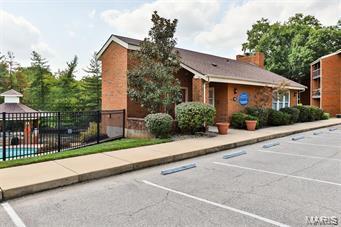 2014 Greenglen Dr Unit 101, Saint Louis, MO 63122 - uncovered parking lot featuring fence