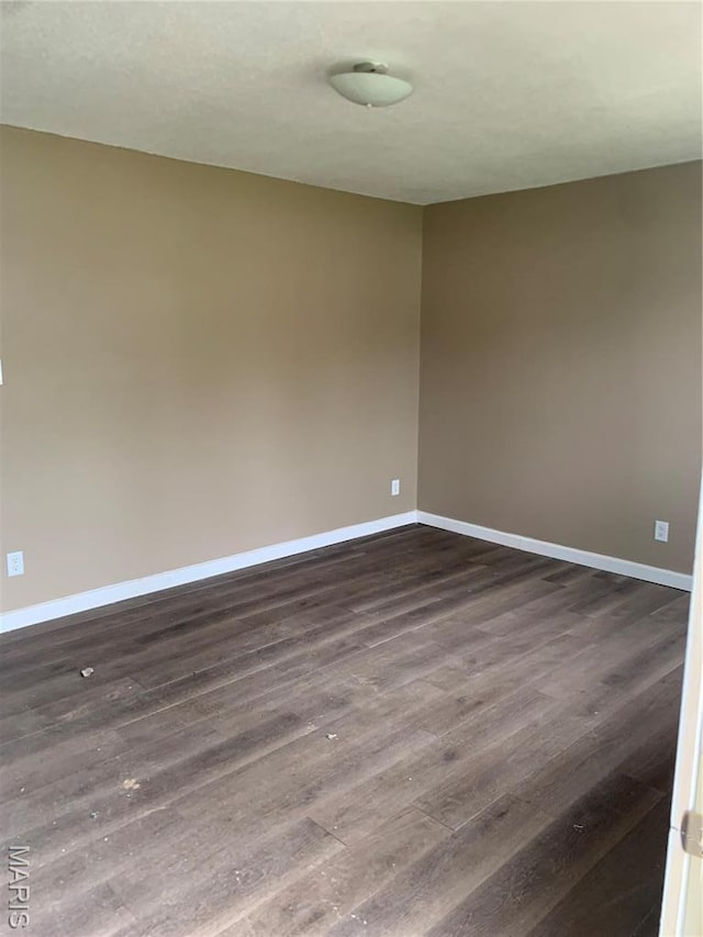 200 Easton St, Bonne Terre, MO 63628 - spare room featuring baseboards and dark wood finished floors