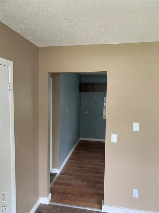 200 Easton St, Bonne Terre, MO 63628 - spare room featuring wood finished floors, baseboards, and a textured ceiling