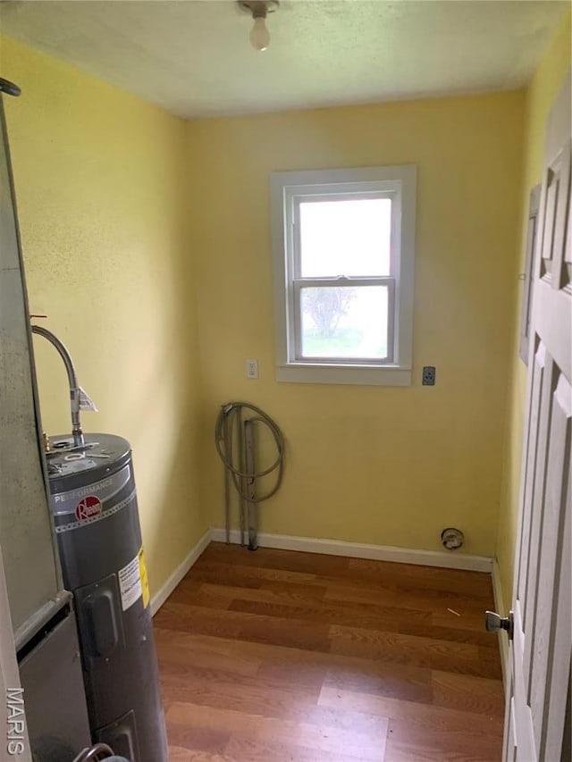 200 Easton St, Bonne Terre, MO 63628 - laundry room featuring wood finished floors, water heater, and baseboards