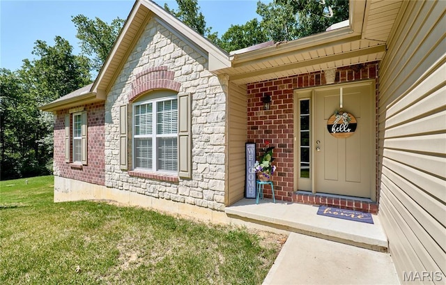 440 Winchester Way, Winfield, MO 63389 - view of exterior entry with brick siding and a yard