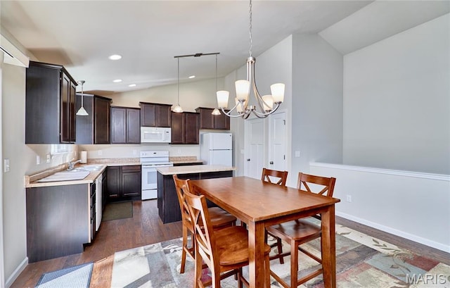 440 Winchester Way, Winfield, MO 63389 - dining room with a chandelier, high vaulted ceiling, dark wood-style floors, and recessed lighting