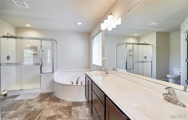 440 Winchester Way, Winfield, MO 63389 - full bathroom with a garden tub, a shower stall, double vanity, recessed lighting, and stone finish flooring