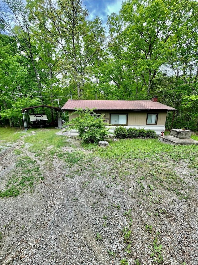 6405 Robin Ln, French Village, MO 63036 - view of front of house with a carport, a chimney, and metal roof
