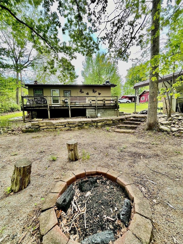 6405 Robin Ln, French Village, MO 63036 - rear view of house featuring an outdoor fire pit and a wooden deck