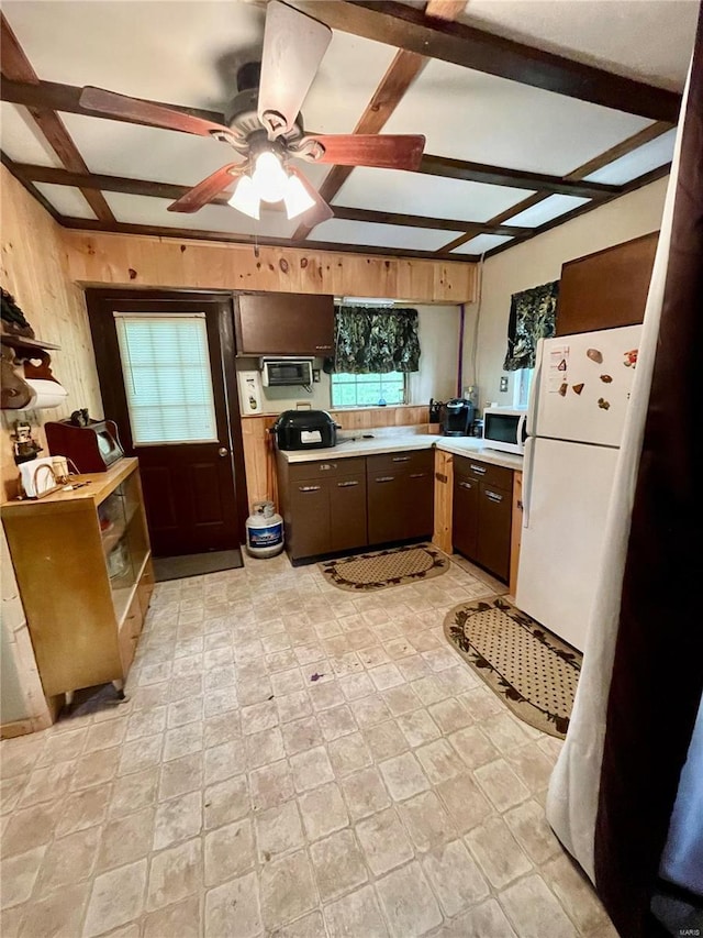 6405 Robin Ln, French Village, MO 63036 - kitchen featuring white appliances, light countertops, beam ceiling, a ceiling fan, and wooden walls