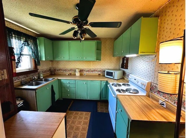 2520 State St, Granite City, IL 62040 - kitchen featuring green cabinets, white appliances, wallpapered walls, ceiling fan, and a sink