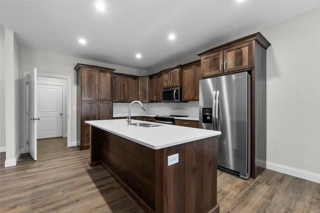 16 Creekside Way, Cape Girardeau, MO 63701 - kitchen with appliances with stainless steel finishes, a sink, baseboards, wood finished floors, and light countertops