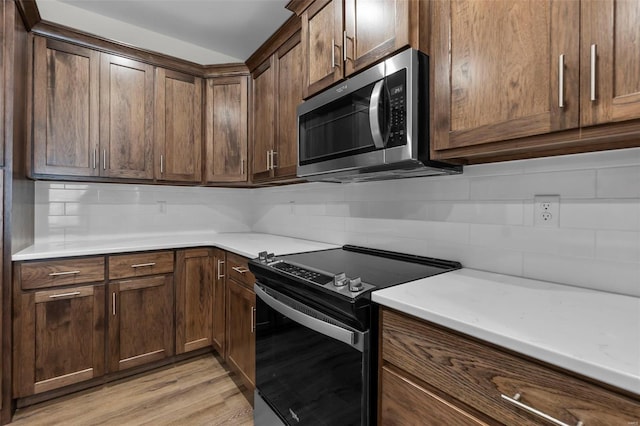 16 Creekside Way, Cape Girardeau, MO 63701 - kitchen with stainless steel microwave, electric range, tasteful backsplash, and light countertops