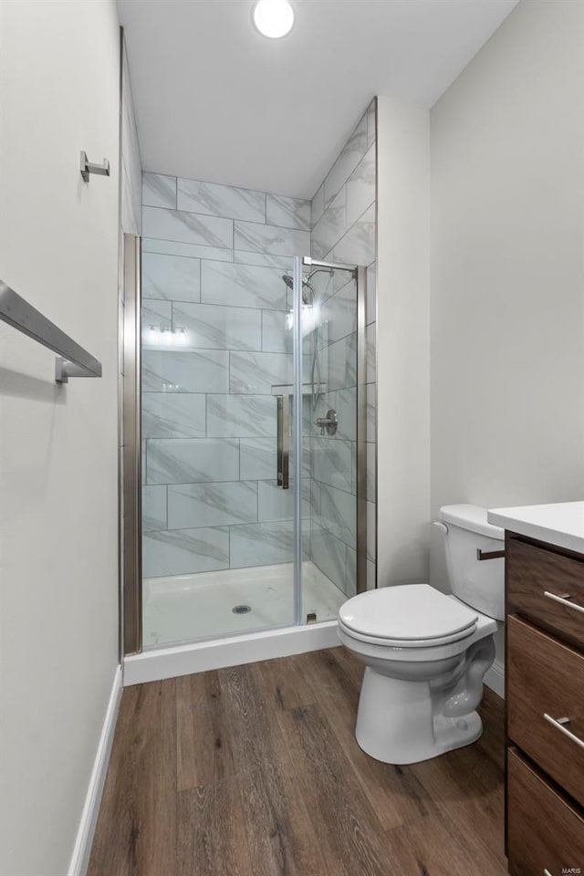 16 Creekside Way, Cape Girardeau, MO 63701 - bathroom with wood finished floors, vanity, a shower stall, toilet, and baseboards