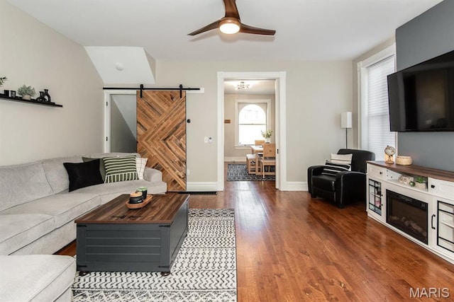 2712 Potomac St, Saint Louis, MO 63118 - living room featuring wood finished floors, ceiling fan, a barn door, and baseboards