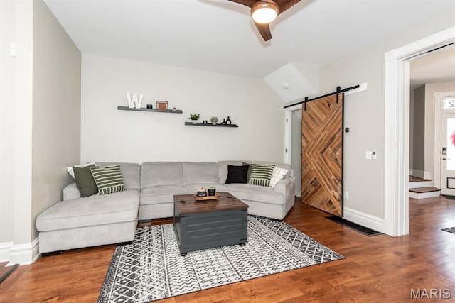 2712 Potomac St, Saint Louis, MO 63118 - living room with a barn door, wood finished floors, ceiling fan, and baseboards
