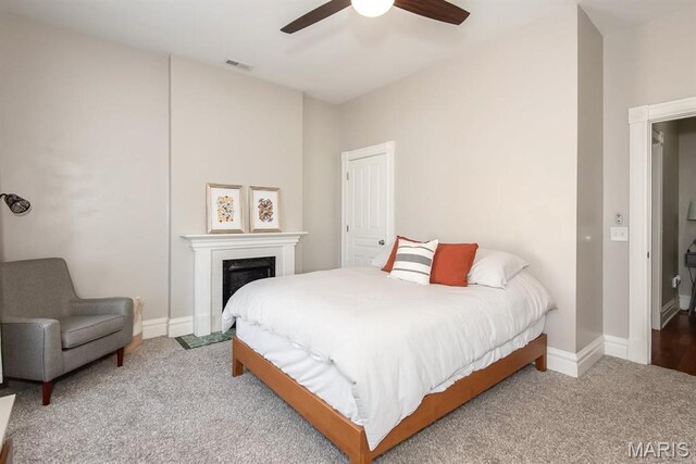 2712 Potomac St, Saint Louis, MO 63118 - carpeted bedroom with baseboards, a fireplace, and ceiling fan